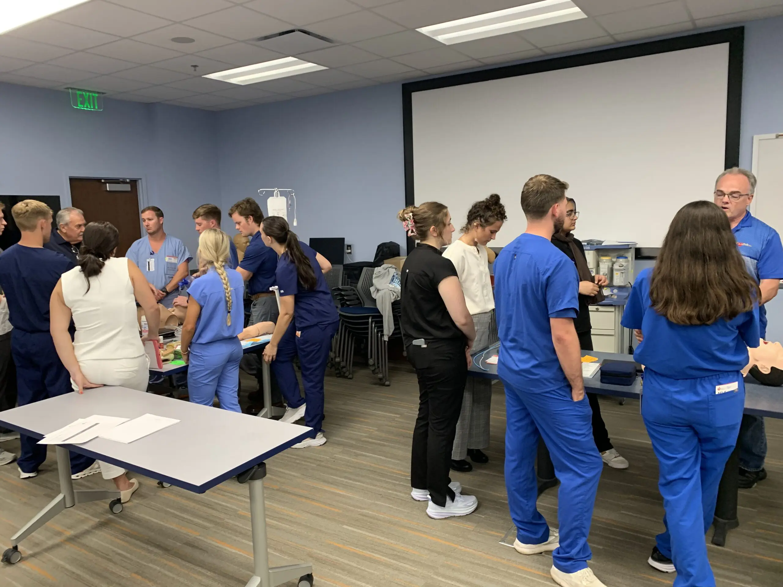 People learning CPR in classroom setting